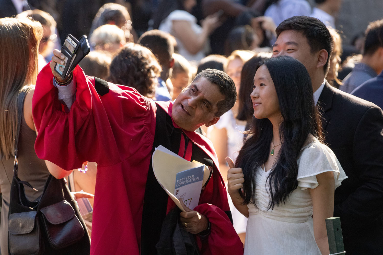 Harvard College Dean Rakesh Khurana snaps a selfie with students at the Class of 2027 Convocation.