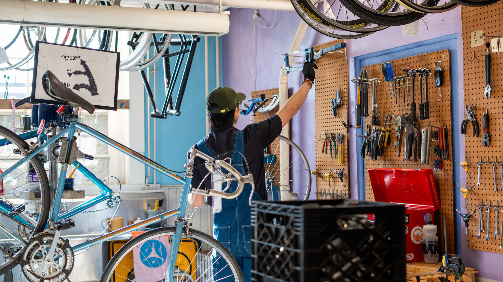 At his workstation, Julian K. Li ’25 prepares tools to adjust an off-center bike wheel. Li is one of the students who runs Quad Bikes, an undergraduate-run bicycle repair shop that reopened in the fall of 2022 following a two-year hiatus due to the Covid-19 pandemic.