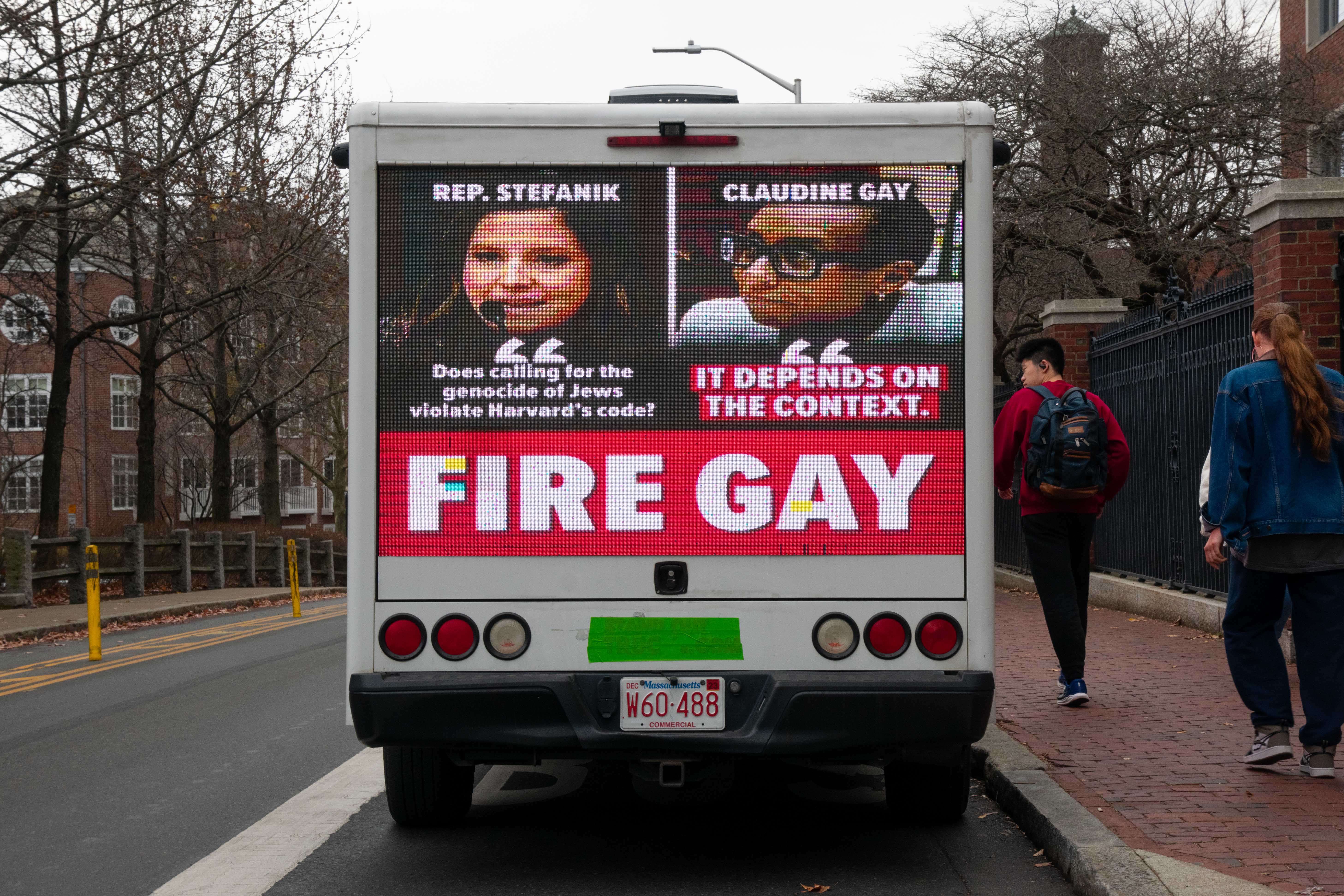 A truck with digital billboards reading “Fire Gay” and featuring photos from Claudine Gay testifying before the House Committee on Education and the Workforce sits parked in front of Lamont Library on Quincy Street. Gay faced dozens of calls for her resignation and was targeted by several digital billboard trucks around campus.