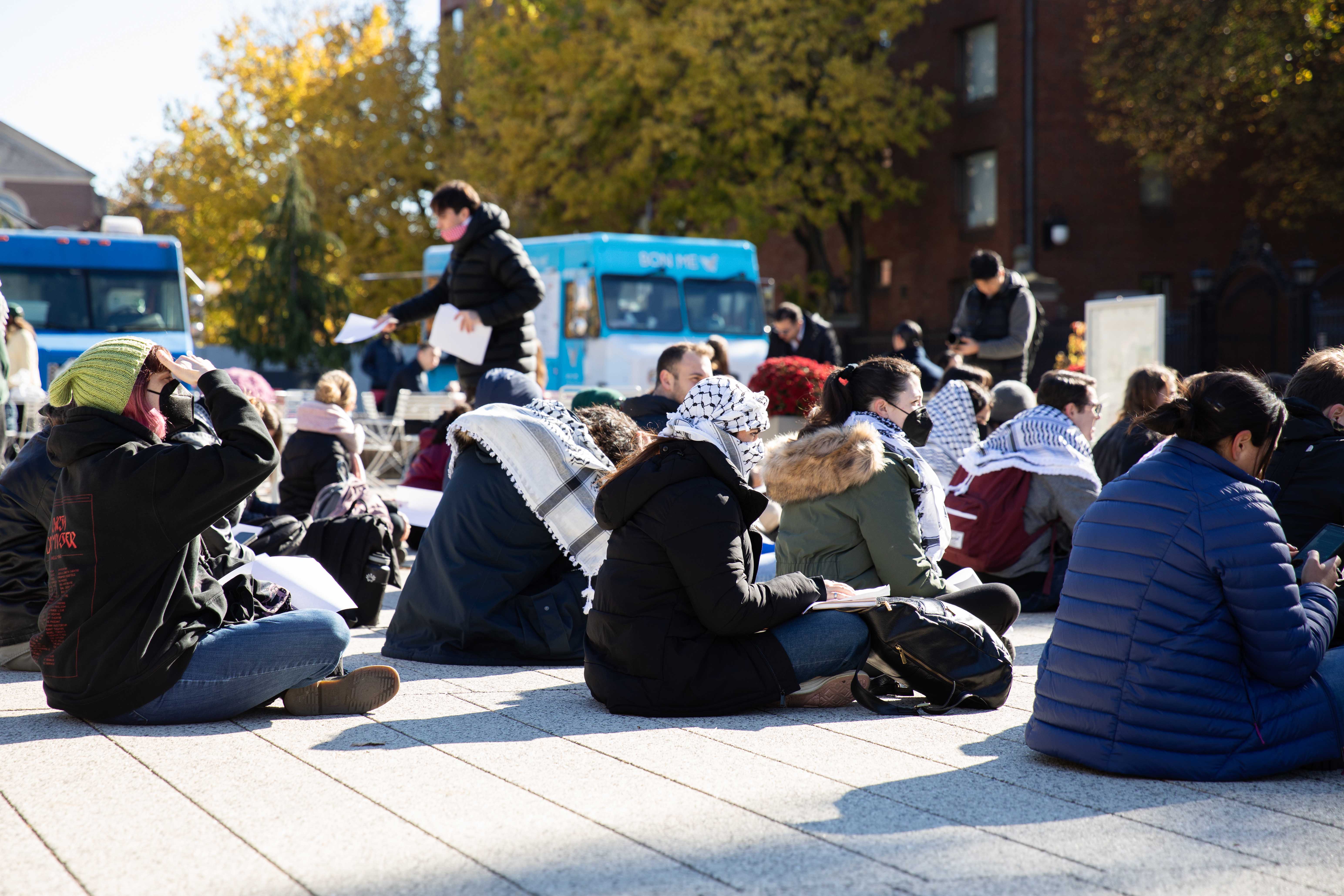 Dozens of Harvard affiliates stage a sit-in at the Science Center Plaza to mourn Palestinian victims of the Israel-Hamas war and protest the bombing of Jabalia Refugee Camp in northern Gaza by Israeli forces.
