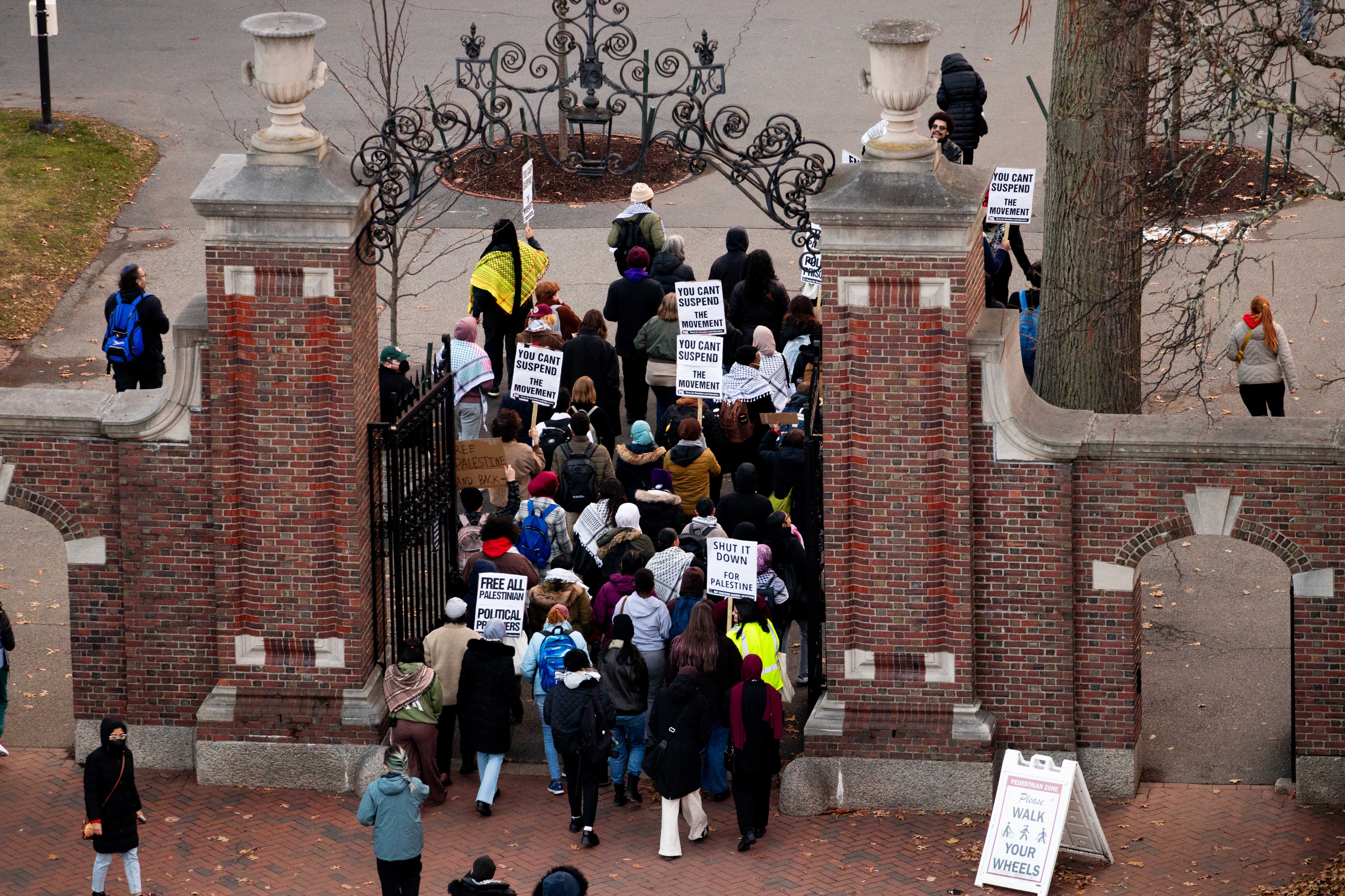 Dozens of demonstrators march to Massachusetts Hall from the Science Center Plaza during a pro-Palestine “week of action.” The week of action included two rallies and a protest sign-making event to call on the University to “stop its complicity in Israeli apartheid.”