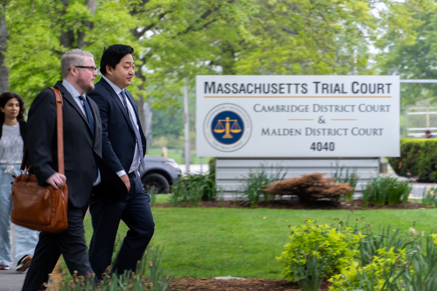 Mark Zhu and his attorney walk into Cambridge District Court for the first round of arraignment hearings for men accused of patronizing a brothel network in Cambridge. The arraignment hearings follow a series of three probable cause hearings in March that publicly identified 34 men, including Cambridge city councilor Paul F. Toner and three Harvard affiliates.