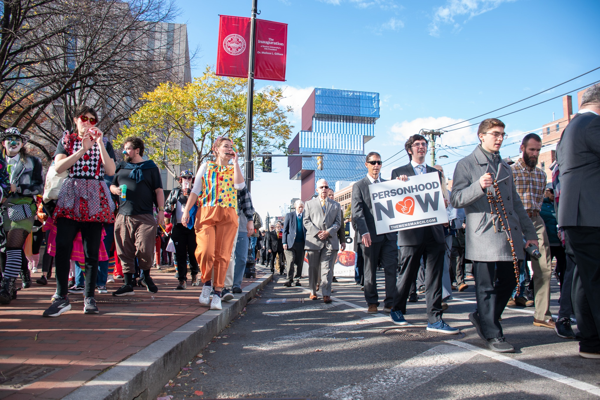 Anti-abortion demonstrators march through Boston as part of the National Men’s March to Abolish Abortion. Counter-protesters, many dressed as clowns, joined a satirical “Clown March” to ridicule the event and its religious messaging, confronting marchers along the route from Allston to Boston Common.