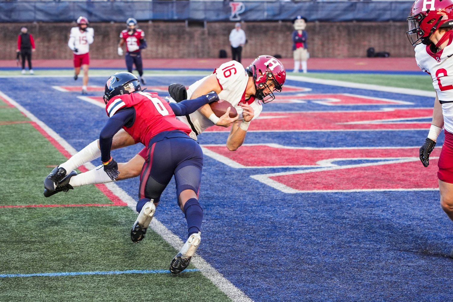 Harvard quarterback Charles DePrima dives into the end zone to tie the game against the University of Pennsylvania late in the fourth quarter. A last-minute field goal secured the Crimson a 31-28 victory and clinched them a share of the Ivy League title for the second straight season.