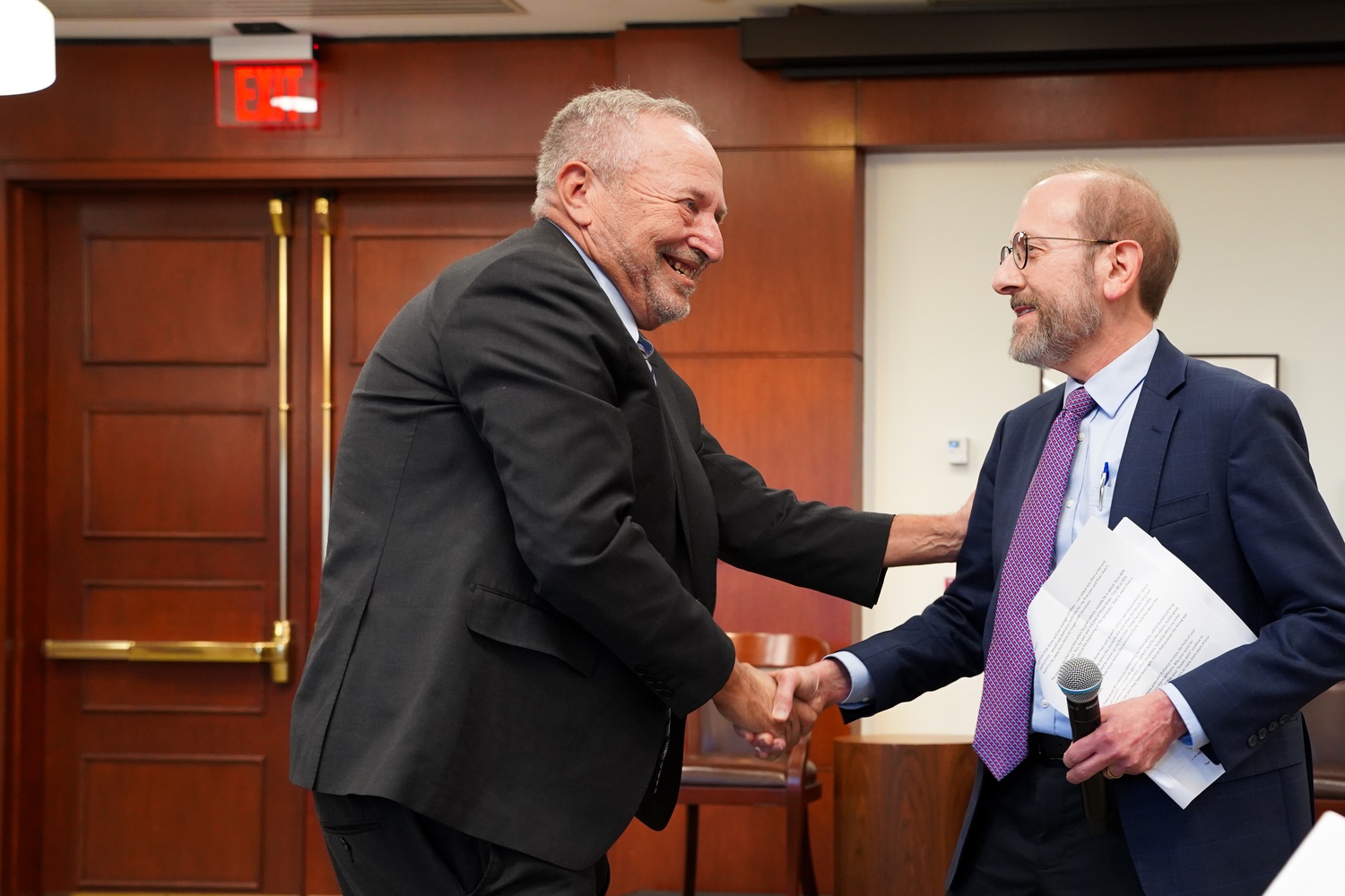 Former University President Lawrence H. Summers greets Harvard President Alan M. Garber ’76 at a symposium celebrating Summers’ 70th birthday.