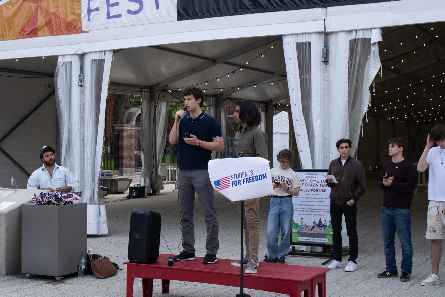 Students speak at a “Students for Freedom” protest in the Science Center Plaza urging Harvard to reject Department of Homeland Security demands for student records and to reinstate affinity graduation ceremonies. The rally drew more than 80 attendees and included remarks from student leaders and faculty.