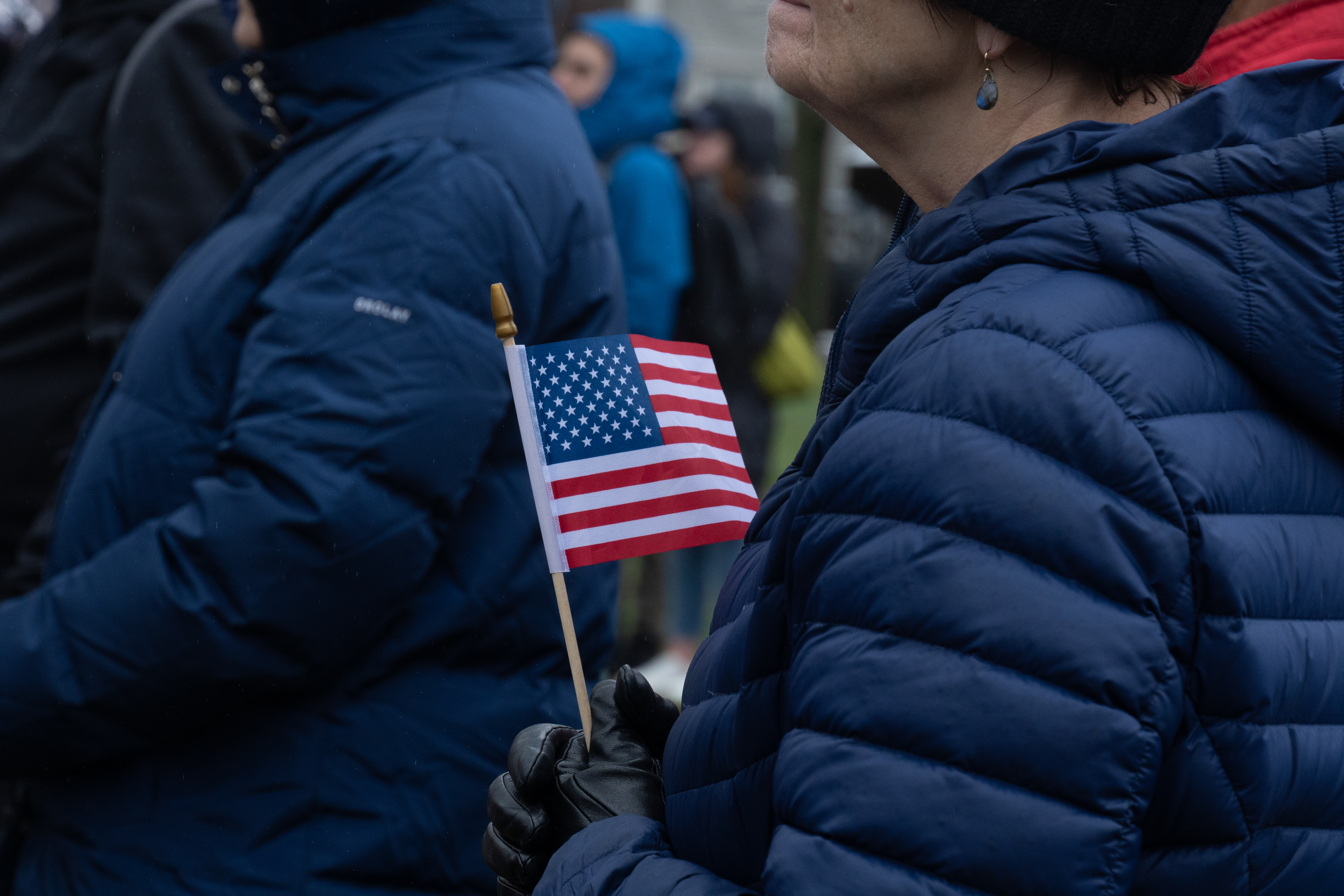 A man holds an American flag.
