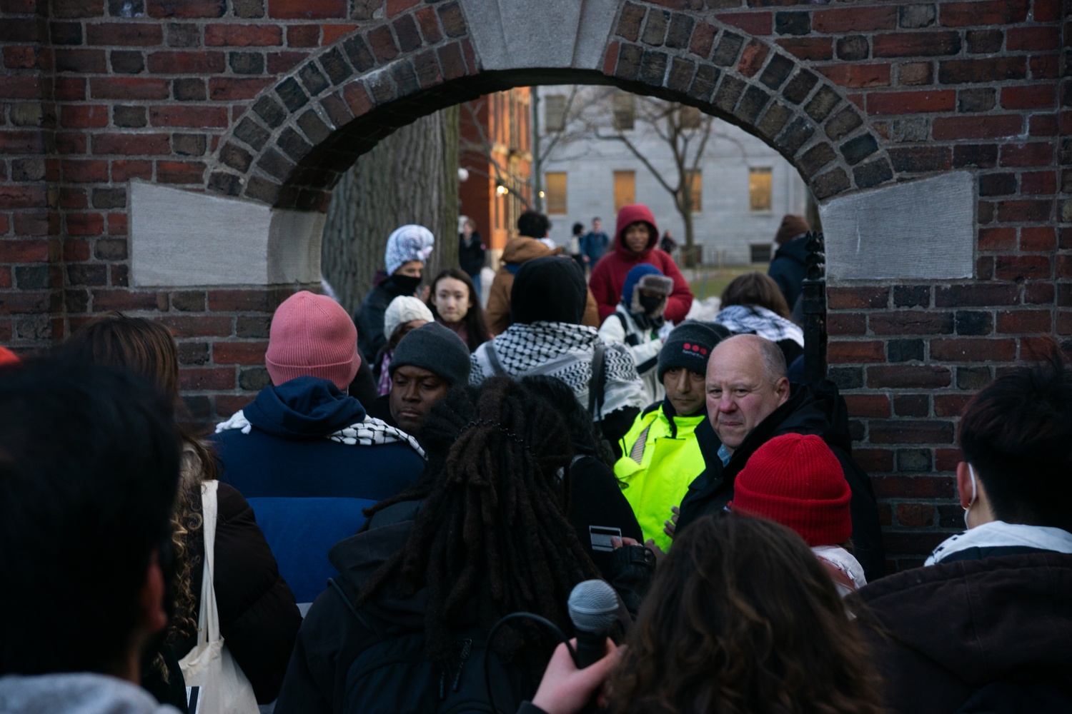A guard checks student IDs outside the Science Center gate of Harvard Yard, which remained closed for several hours following a protest organized by Harvard Out of Occupied Palestine. The rally opposed Israel’s deployment of tanks into the West Bank and marked HOOP’s first major demonstration of the spring semester.