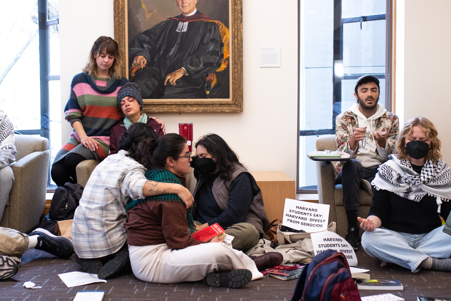 Harvard Divinity School students silently pray during a “pray-in” protest at the Divinity School library organized by Jewish students and open to all faiths. The 45-minute demonstration included participants holding religious texts like the Quran, Torah, and Bible as they called for divestment from Israel’s war in Gaza.