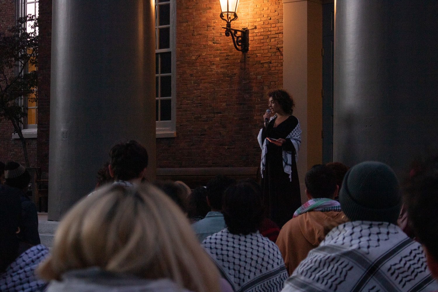 Students gather on the steps of Memorial Church for a candlelit vigil hosted by the Harvard Undergraduate Palestine Solidarity Committee to mark one year since the start of the war in Gaza. The vigil concluded a two-day campus art installation commemorating Palestinian deaths.