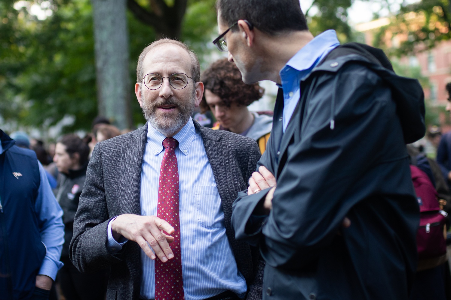 University President Alan M. Garber ’76 stands among more than 400 attendees at the vigil.
