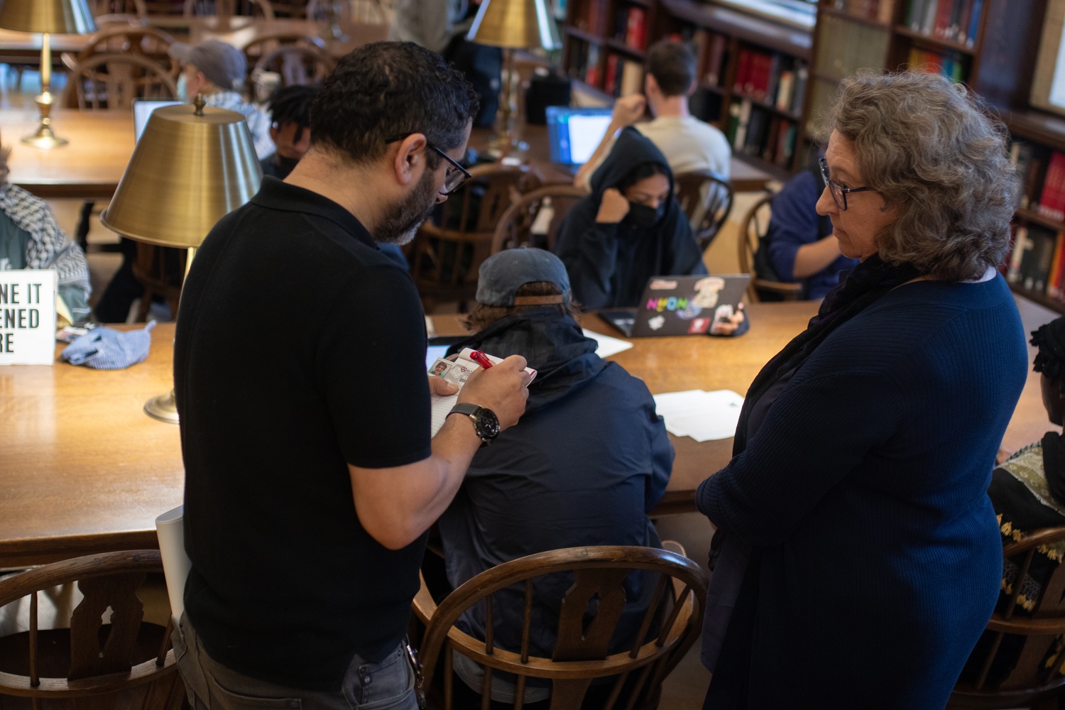 Harvard Out of Occupied Palestine students hold a study-in protest inside Widener Library in opposition to Israeli military actions in Lebanon. Harvard Library staff recorded the ID numbers of participating students and distributed notices citing violations of University policies.